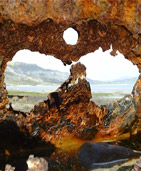 View of Charmouth through a breaker at Lyme Regis